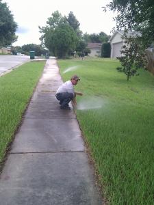 An Antelope Sprinkler Repair team member adjusts a pop up head