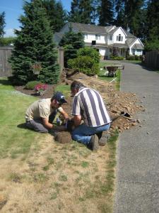 two contractors install a line extension